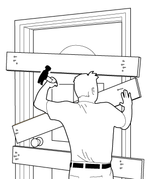 Image de quelqu'un en train de clouer dans planches à une porte pour la garder fermée de manière définitive.